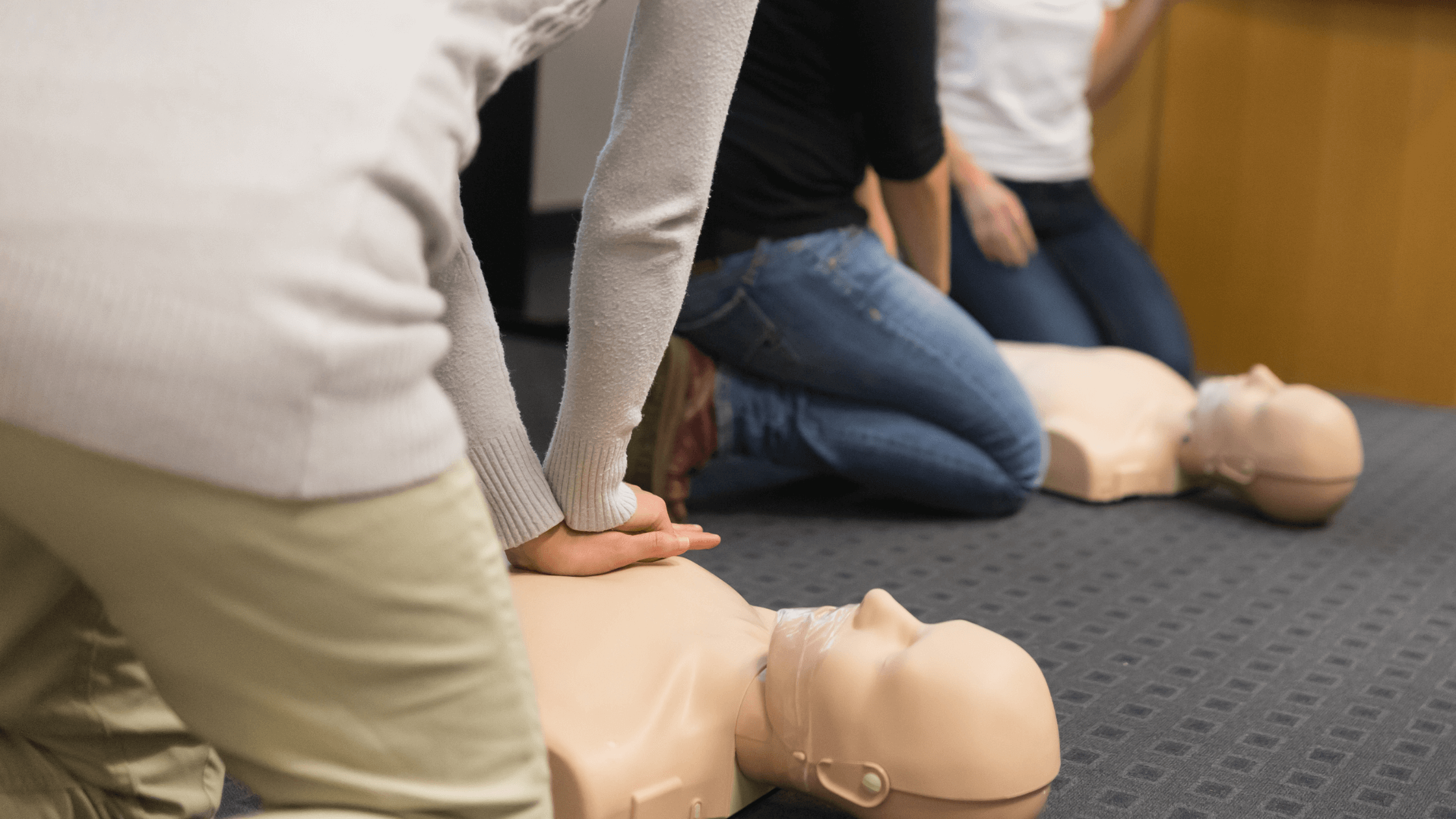 Learners practicing First Aid on CPR dolls